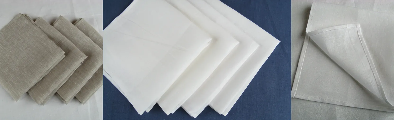 Linen napkins: a set of four in oatmeal and folded white napkins on a dark blue cloth.